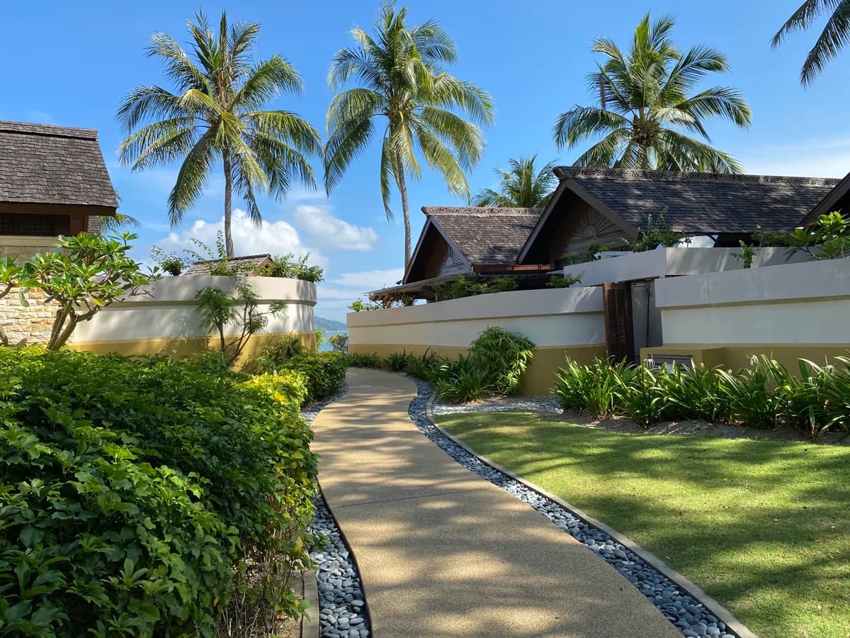 Garden walkway leading to villas among palm trees